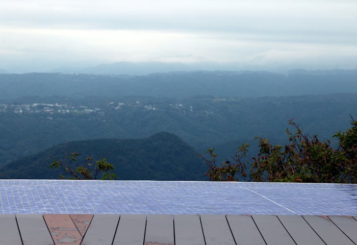Infinity pool overlooking misty mountains