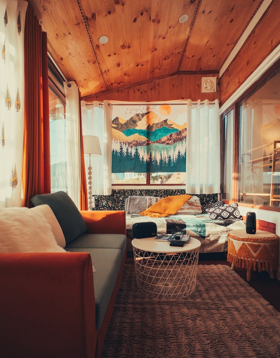 Warm lounge with a mountain tapestry and wide windows