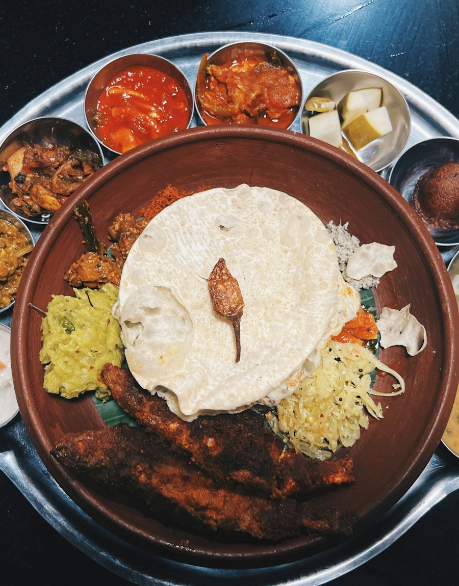 Traditional Kerala meal with fried fish and sides