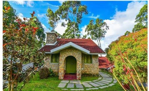 A single stone cottage with an arched wooden door
