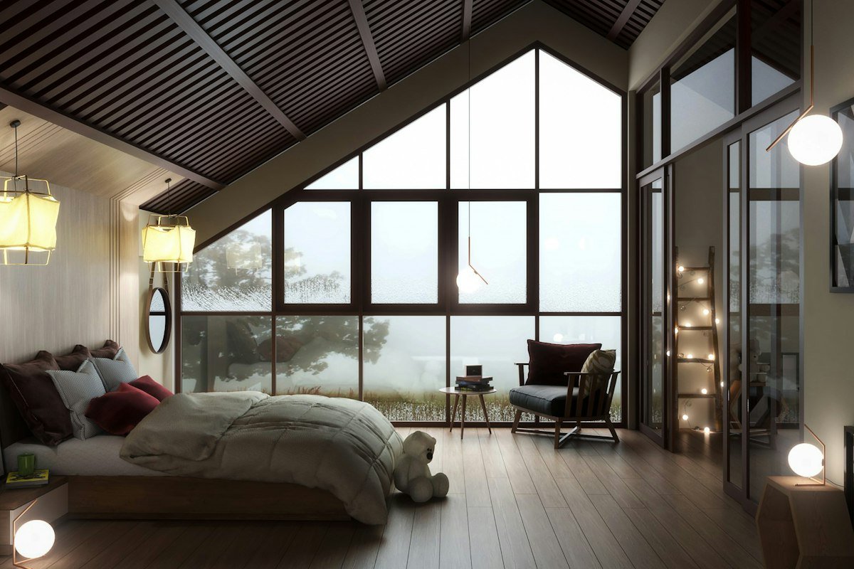 Bedroom with tall windows over a misty valley